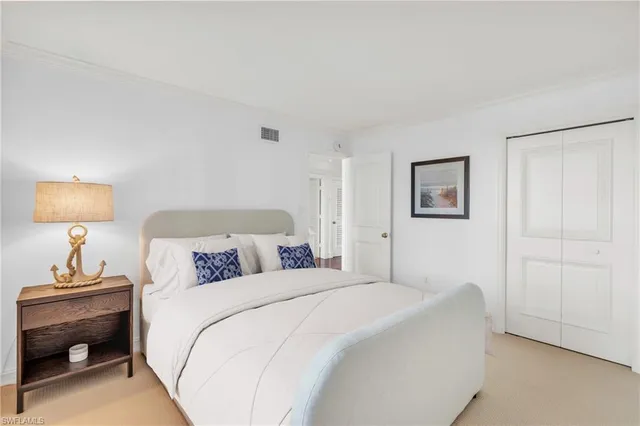 a bedroom with a bed and a lamp