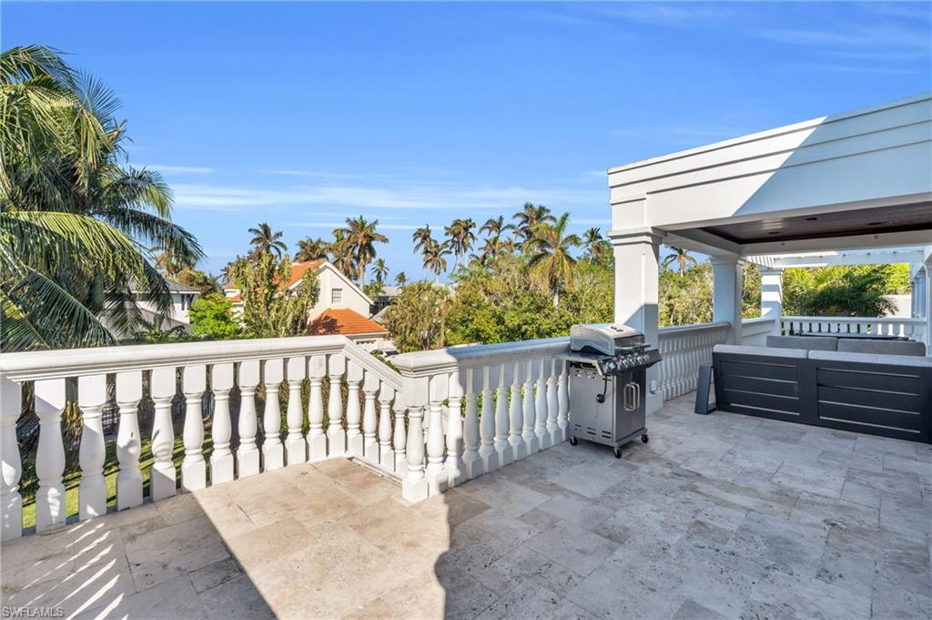 271 Broad Avenue South, Unit 202 Naples, FL 34102 - Photo 14 of 18 a balcony with furniture and a potted plant