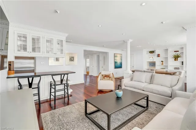 a living room with furniture a rug and a table