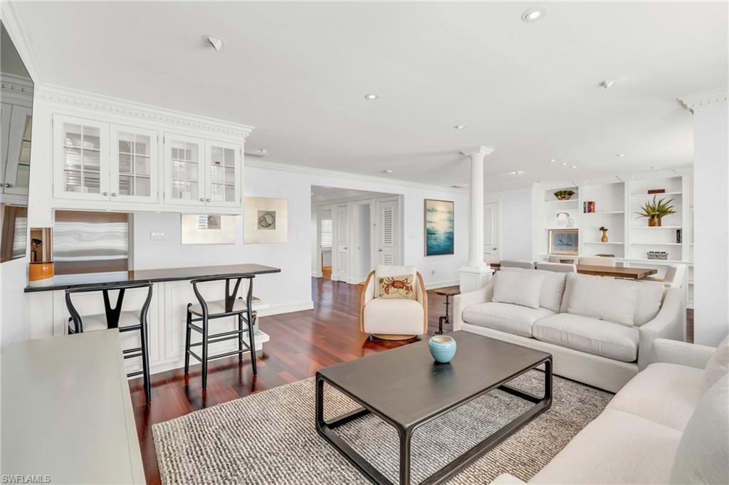 271 Broad Avenue South, Unit 202 Naples, FL 34102 - Photo 3 of 18 a living room with furniture a rug and a table