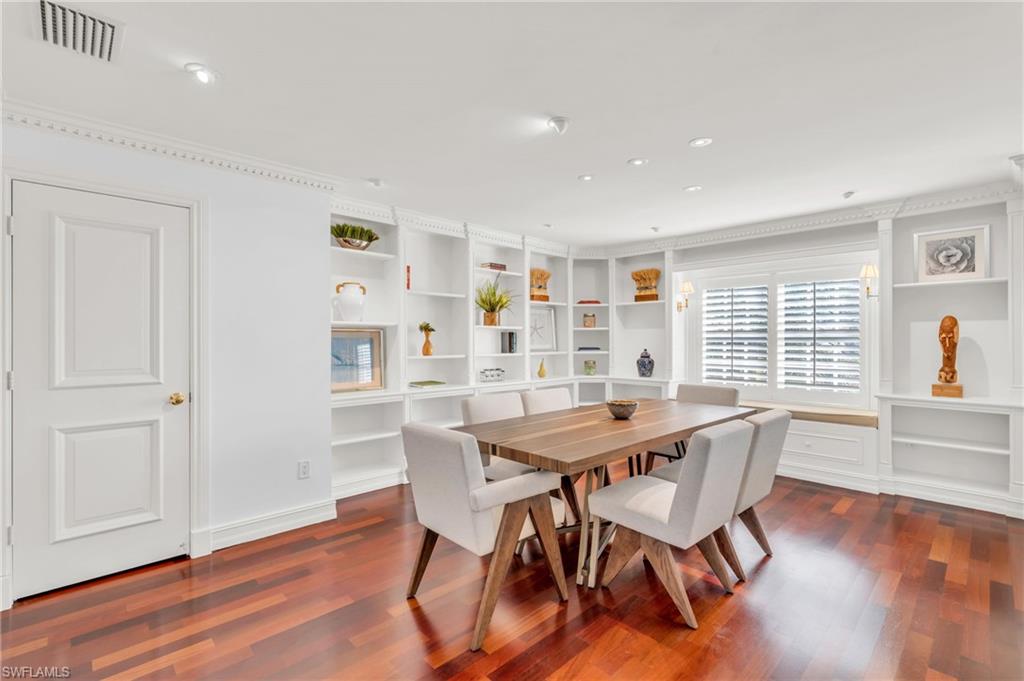 271 Broad Avenue South, Unit 202 Naples, FL 34102 - Photo 4 of 18 a view of a dining room with furniture and wooden floor