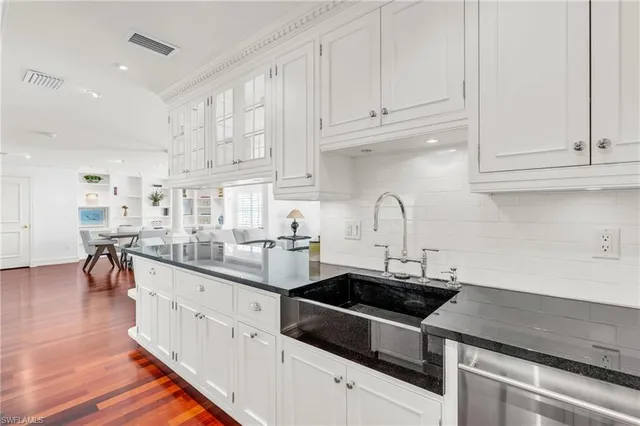 a kitchen with stainless steel appliances granite countertop a sink stove and cabinets