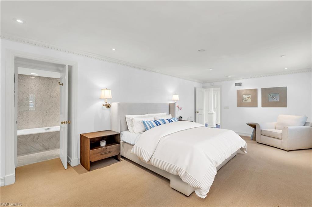 271 Broad Avenue South, Unit 202 Naples, FL 34102 - Photo 7 of 18 a bedroom with a bed and a couch