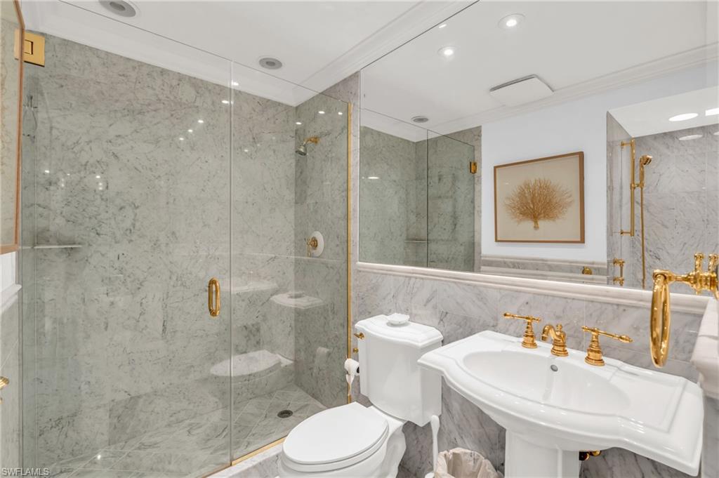 271 Broad Avenue South, Unit 202 Naples, FL 34102 - Photo 8 of 18 a bathroom with a sink toilet and shower