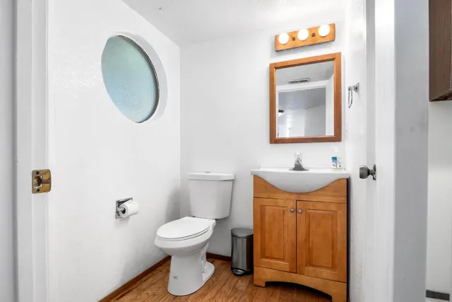 a bathroom with a toilet a sink and a mirror