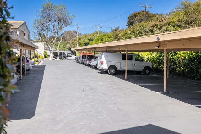 a view of a patio with a table and chairs under an umbrella