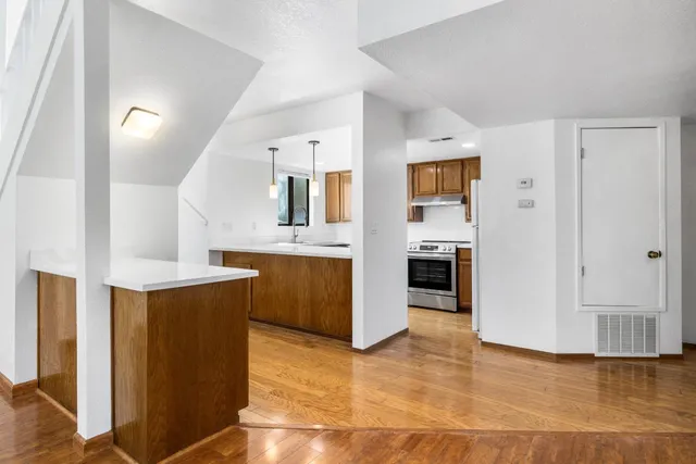 a view of kitchen with stainless steel appliances granite countertop a refrigerator and a sink