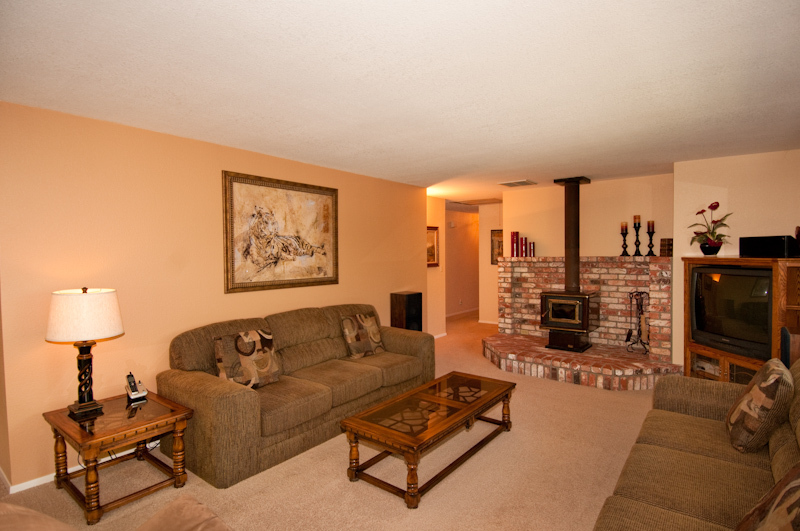 16433 Lower Springs Road Redding, CA 96001 - Photo 8 of 17 a living room with furniture a lamp and a flat screen tv