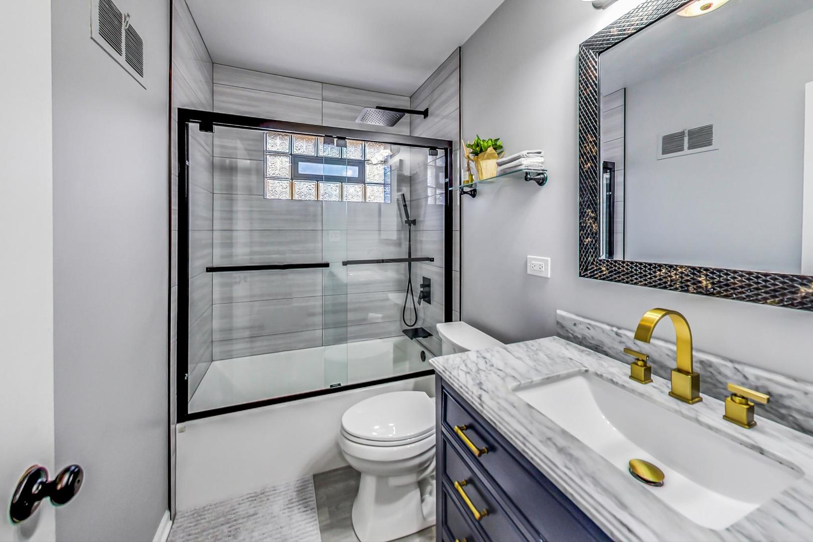 7524 East Prairie Road Skokie, IL 60076 - Photo 15 of 55 a bathroom with a sink toilet and shower