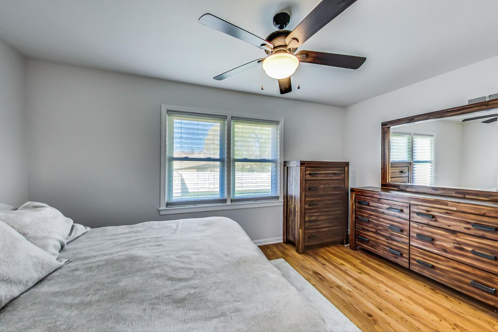 7524 East Prairie Road Skokie, IL 60076 - Photo 19 of 55 a bedroom with a bed and wooden floor