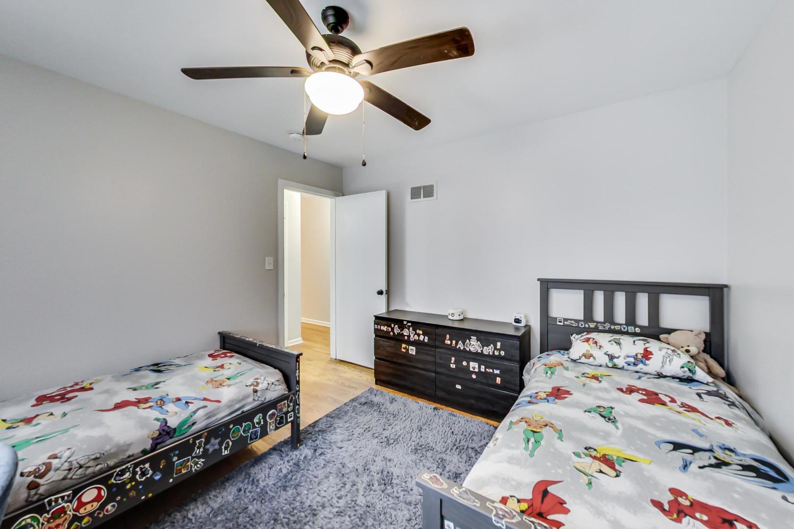 7524 East Prairie Road Skokie, IL 60076 - Photo 24 of 55 a bedroom with a bed and dresser