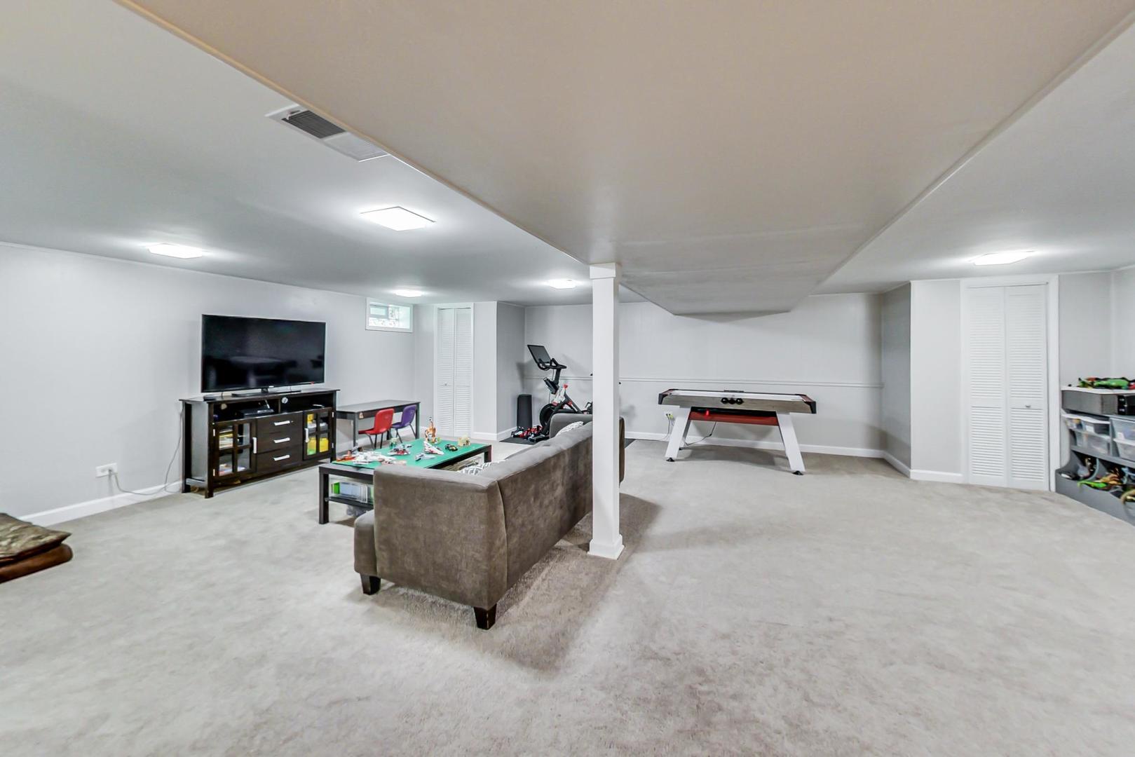 7524 East Prairie Road Skokie, IL 60076 - Photo 26 of 55 a living room with furniture and a flat screen tv