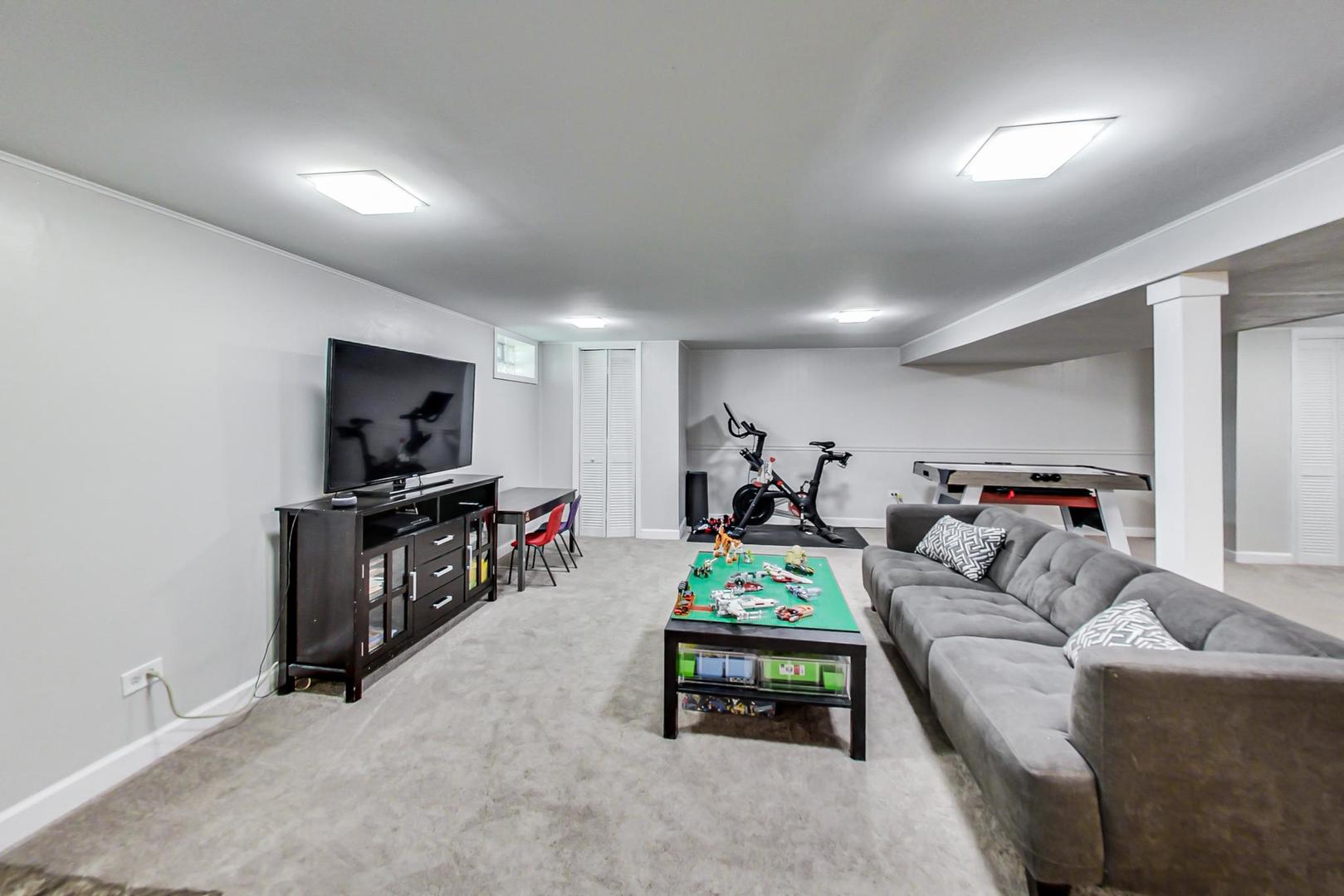 7524 East Prairie Road Skokie, IL 60076 - Photo 28 of 55 a living room with furniture and a flat screen tv