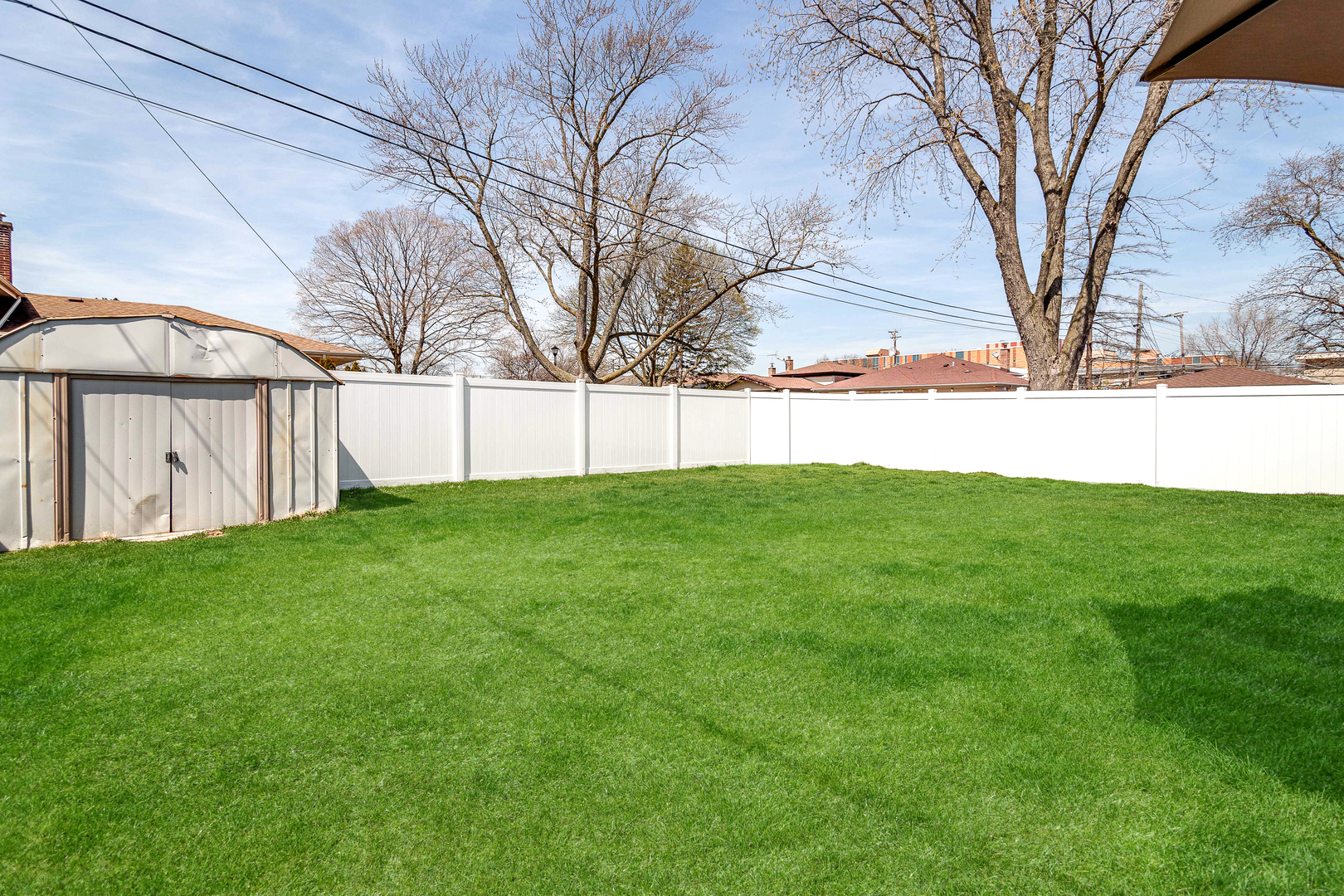 7524 East Prairie Road Skokie, IL 60076 - Photo 41 of 55 a view of a backyard with large trees