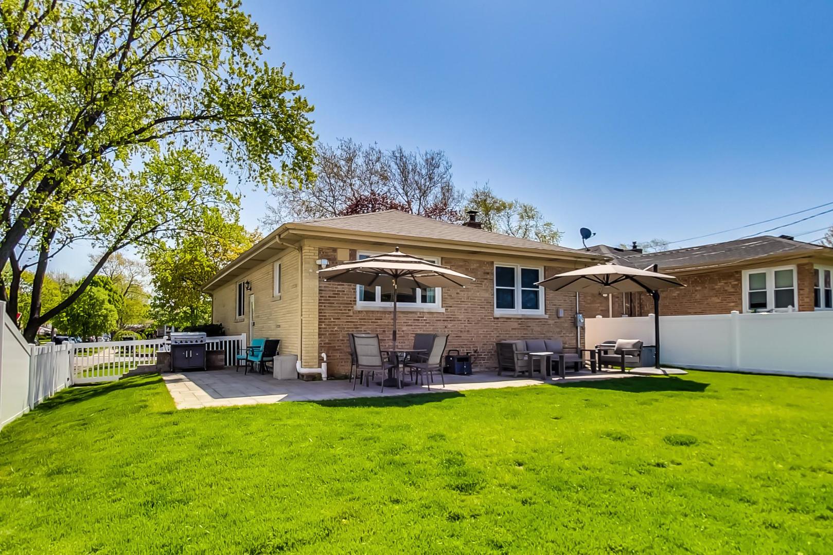 7524 East Prairie Road Skokie, IL 60076 - Photo 45 of 55 a front view of a house with a garden and plants