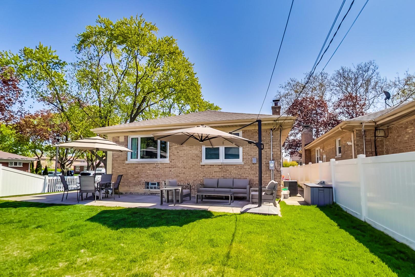 7524 East Prairie Road Skokie, IL 60076 - Photo 46 of 55 a front view of house with yard and outdoor seating