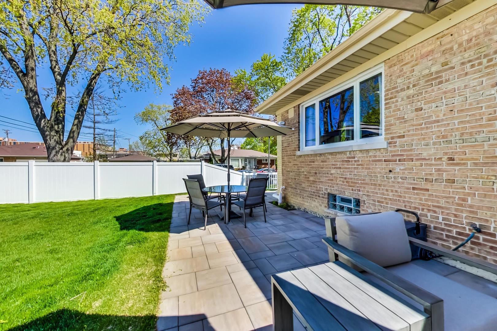 7524 East Prairie Road Skokie, IL 60076 - Photo 50 of 55 a backyard of a house with table and chairs