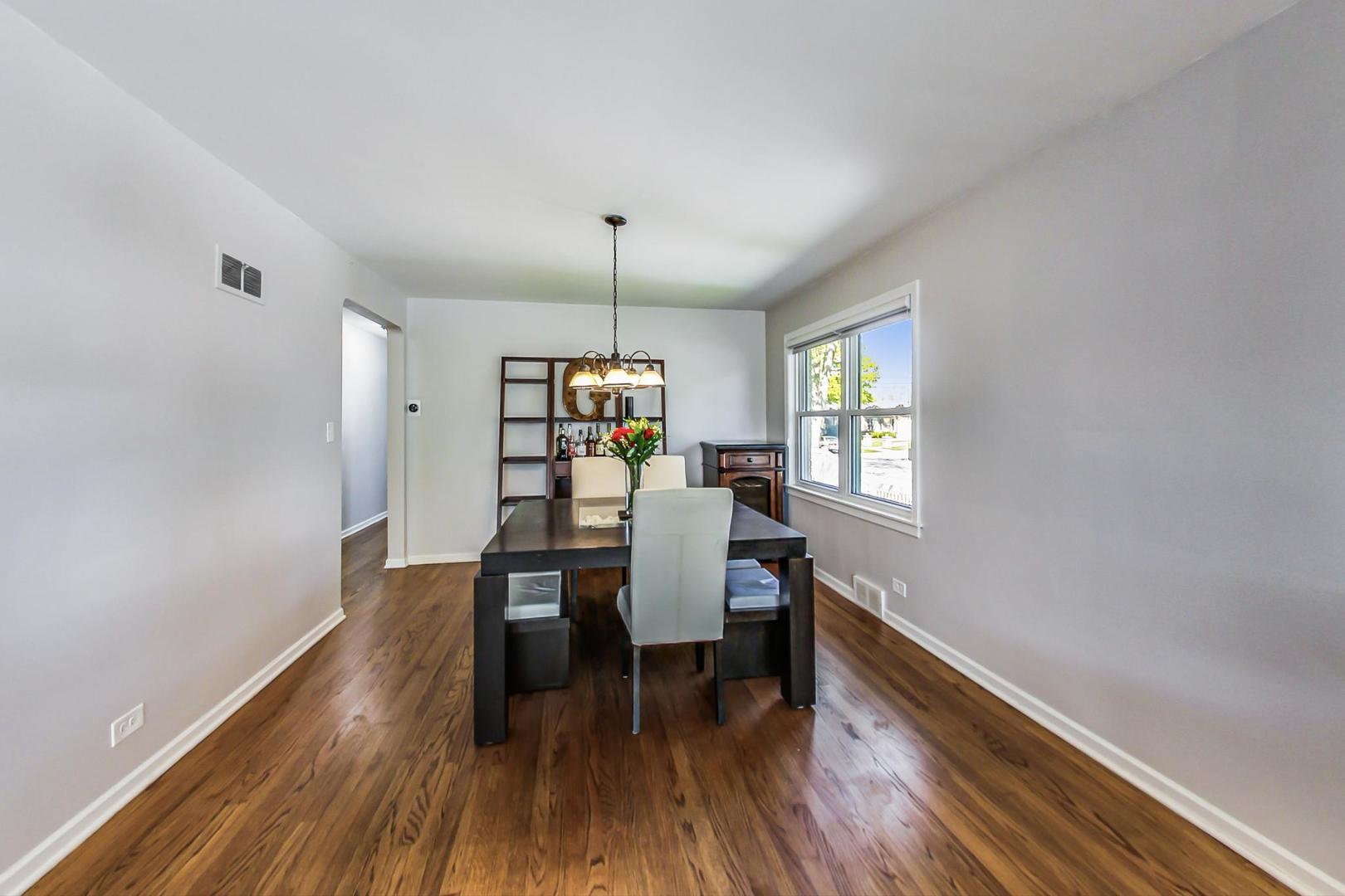 7524 East Prairie Road Skokie, IL 60076 - Photo 8 of 55 a view of a dining room with furniture and wooden floor