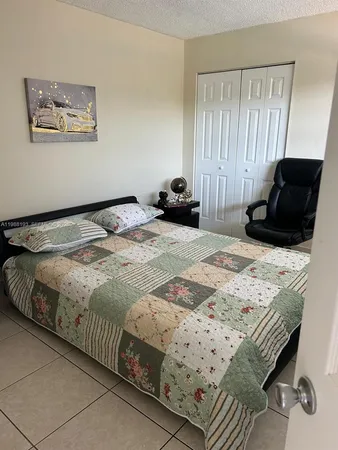 a bedroom with a bed and dresser