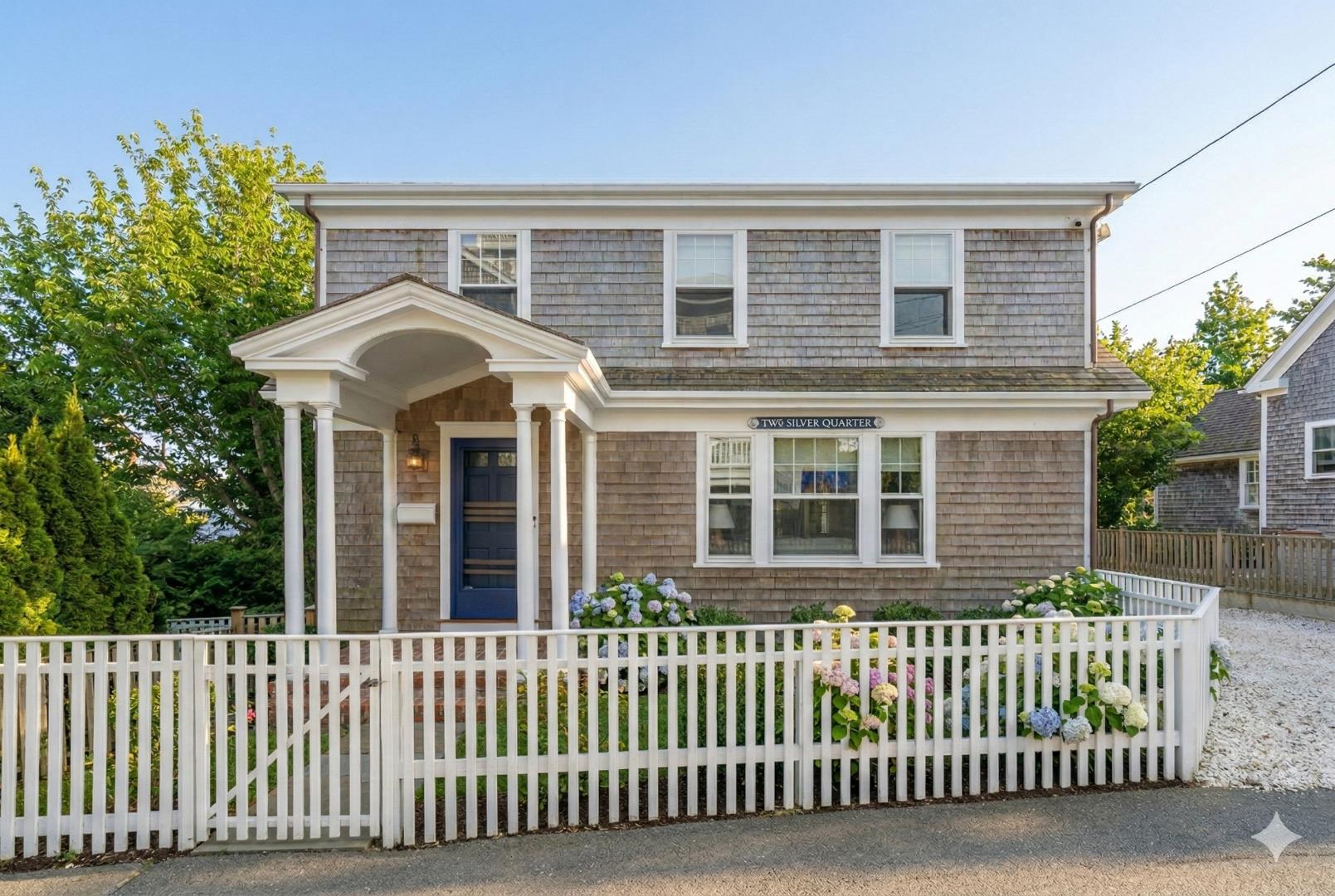 2 Silver Street Nantucket, MA 02554 - Photo 1 of 30 a front view of a house with a garden