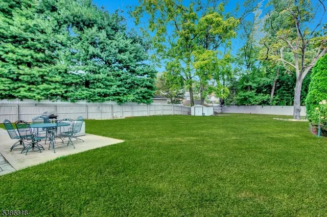 a view of a backyard with a table and chairs