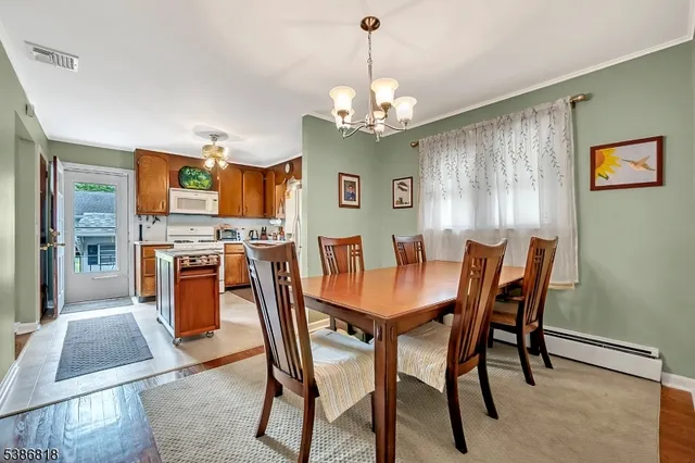 a view of a dining room with furniture and chandelier