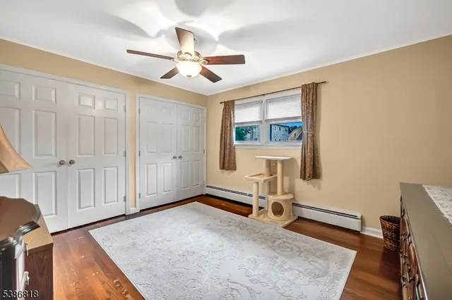 a view of a livingroom with wooden floor and a ceiling fan