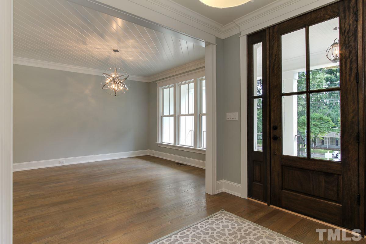 4913 Latimer Road Raleigh, NC 27609 - Photo 4 of 25 a view of an empty room with wooden floor and a window