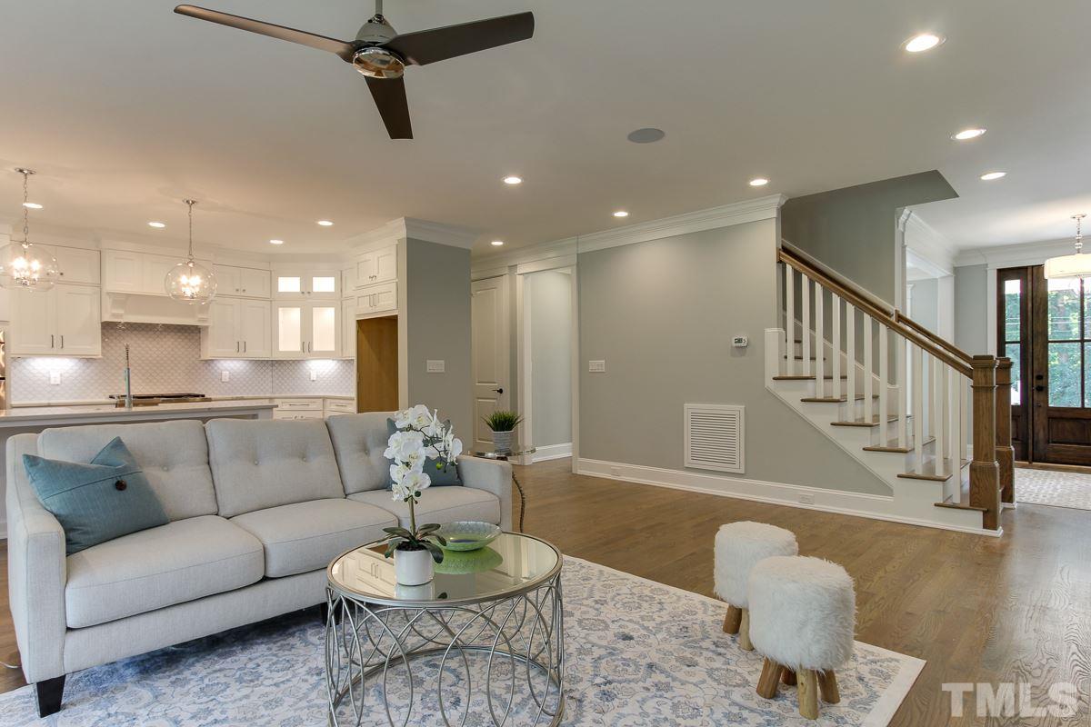 4913 Latimer Road Raleigh, NC 27609 - Photo 8 of 25 a living room with furniture kitchen view and a wooden floor