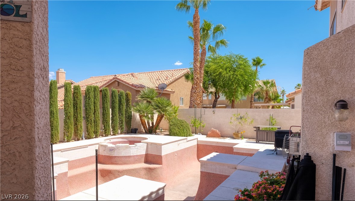 3704 North Campbell Road Las Vegas, NV 89129 - Photo 37 of 38 An inviting backyard oasis offers a built-in spa and mature landscaping, perfect for relaxation.