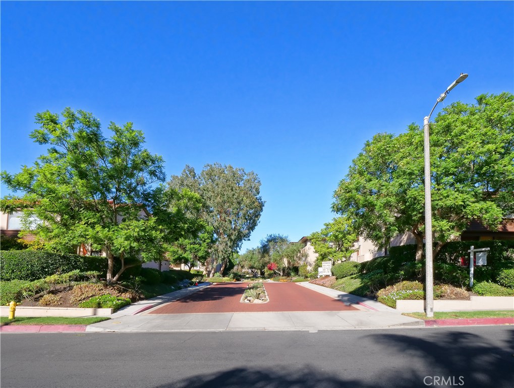 a view of a street with a house in the background
