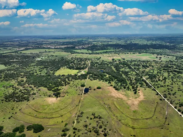 an aerial view of a house with a yard
