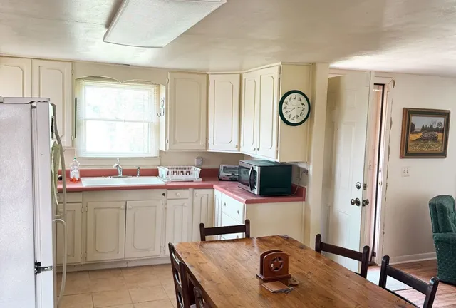 a view of a house with backyard porch and sitting area