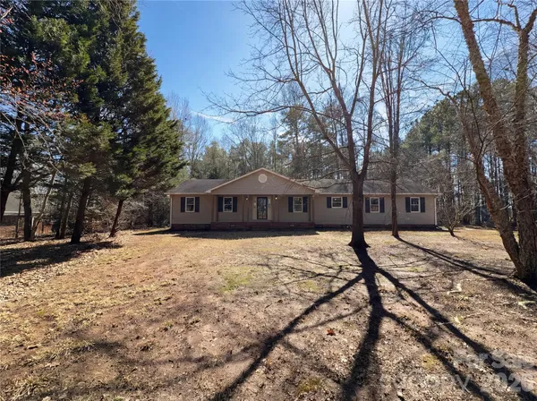 a front view of a house with a yard covered in snow