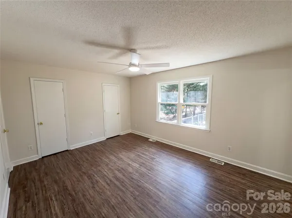 a view of a room with wooden floor and a sink