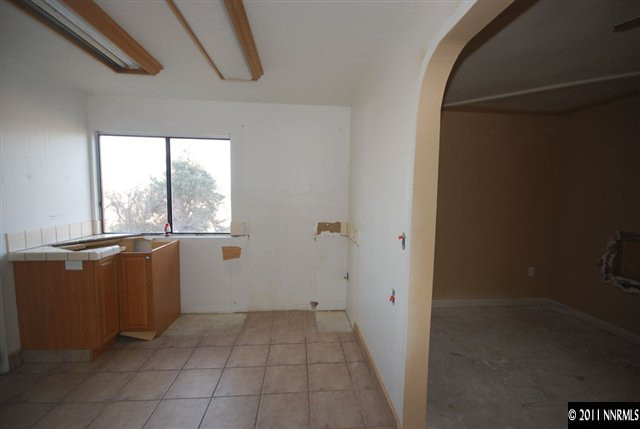 1095 Hot Springs Road Reno, NV 89521 - Photo 5 of 13 a view of an empty room with a window