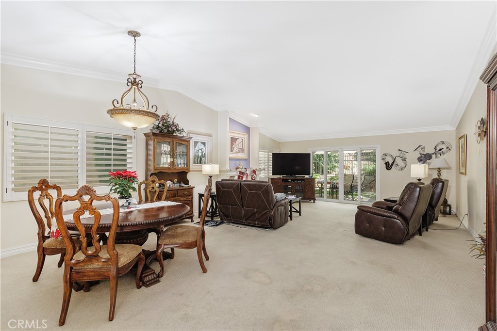 547 Vía Zapata Riverside, CA 92507 - Photo 5 of 36 The open dining & living room has vaulted ceilings and a gas fireplaace.