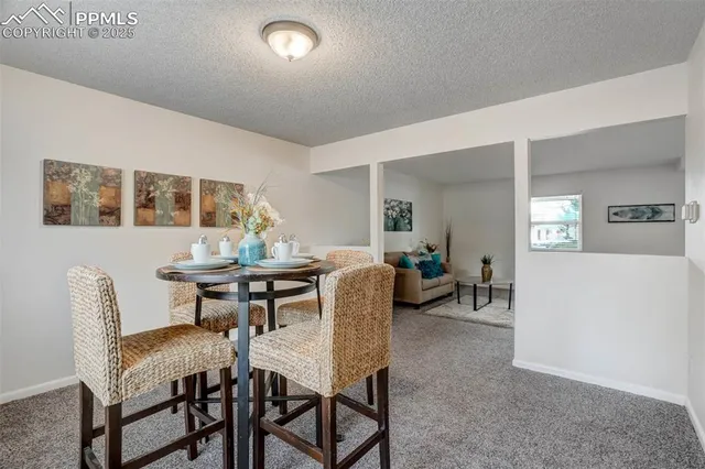 a view of a dining room with furniture and a livingroom