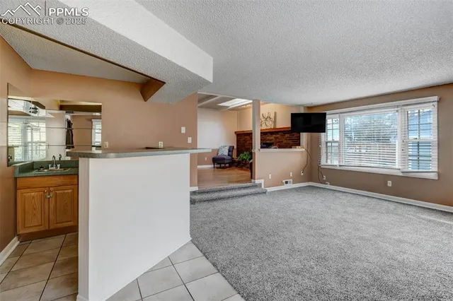 a kitchen with a refrigerator and white cabinets
