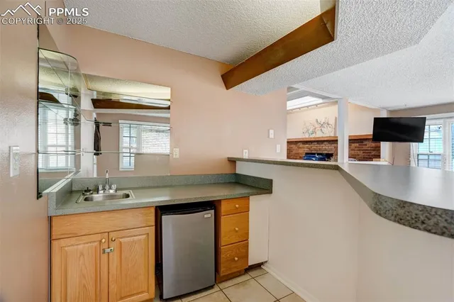 a kitchen with stainless steel appliances granite countertop a sink a stove and cabinets