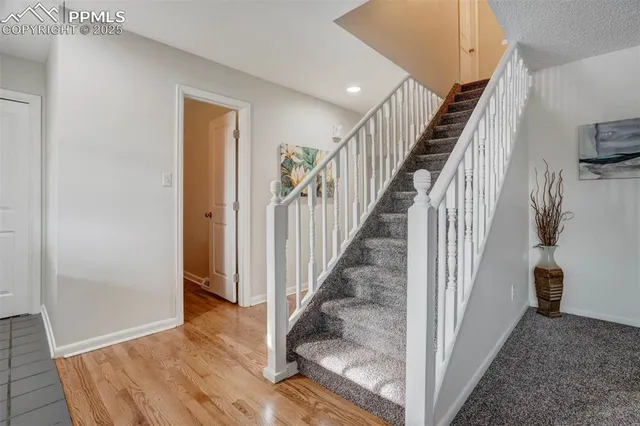 a view of a hallway with wooden floor and entryway