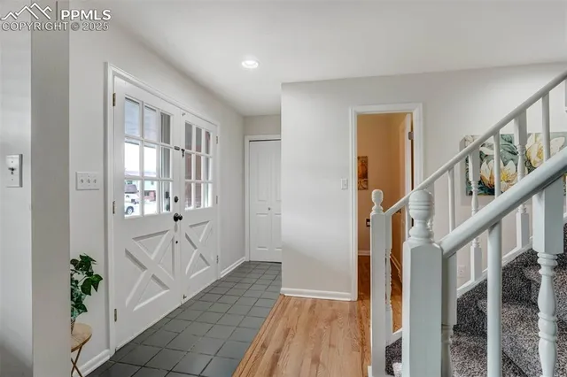 a view of an entryway with wooden floor and windows