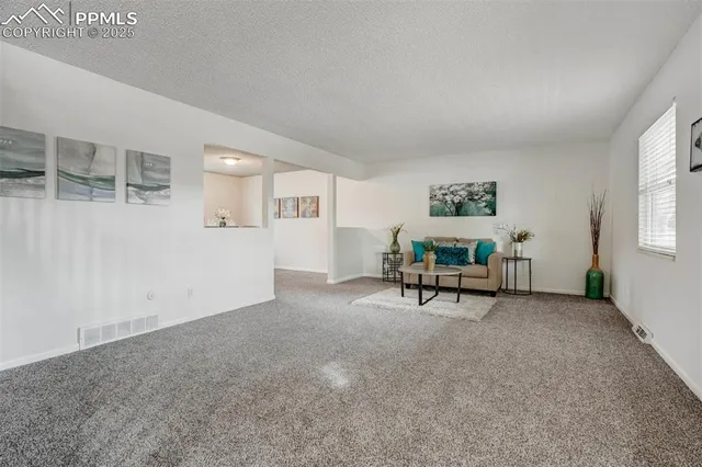 a view of a livingroom with furniture and a window
