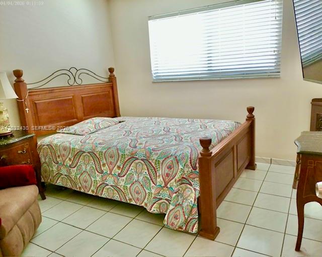 6527 West 22nd Lane Hialeah, FL 33016 - Photo 12 of 18 a bedroom with a bed and a window