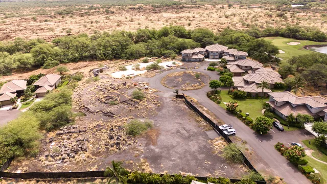 a large kitchen with stainless steel appliances kitchen island granite countertop a refrigerator a sink a stove and white cabinets