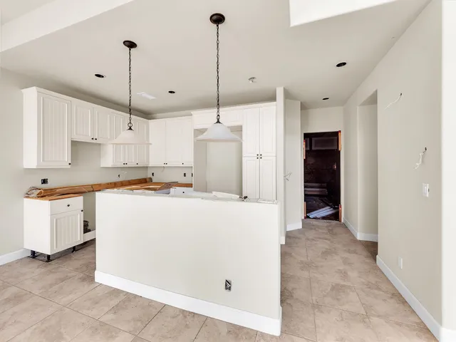 an aerial view of residential houses with outdoor space and swimming pool