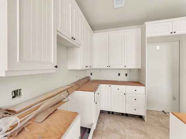 an aerial view of a house with swimming pool and large trees