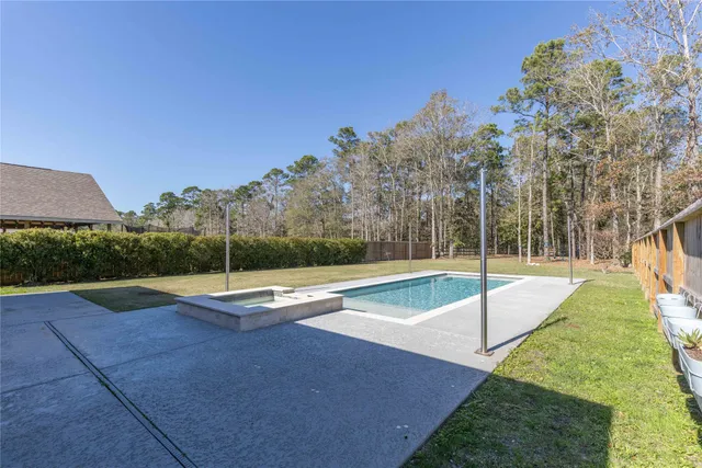 a view of a swimming pool with a bench in front of it