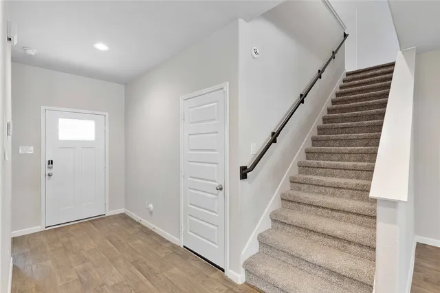 a view of kitchen with sink and refrigerator