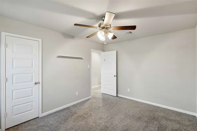 a view of room with a ceiling fan and window